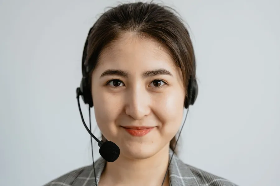 smiling customer service representative helping a website visitor
